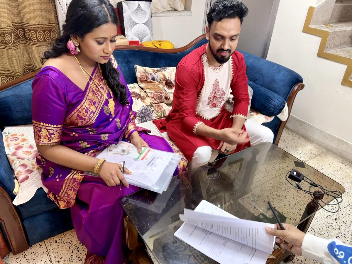 The couple in a quiet moment over paperwork between rituals