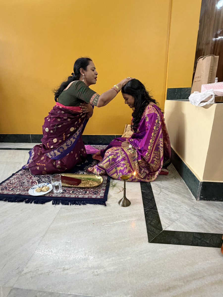 Woman in green blessing Rituparna during the ceremony