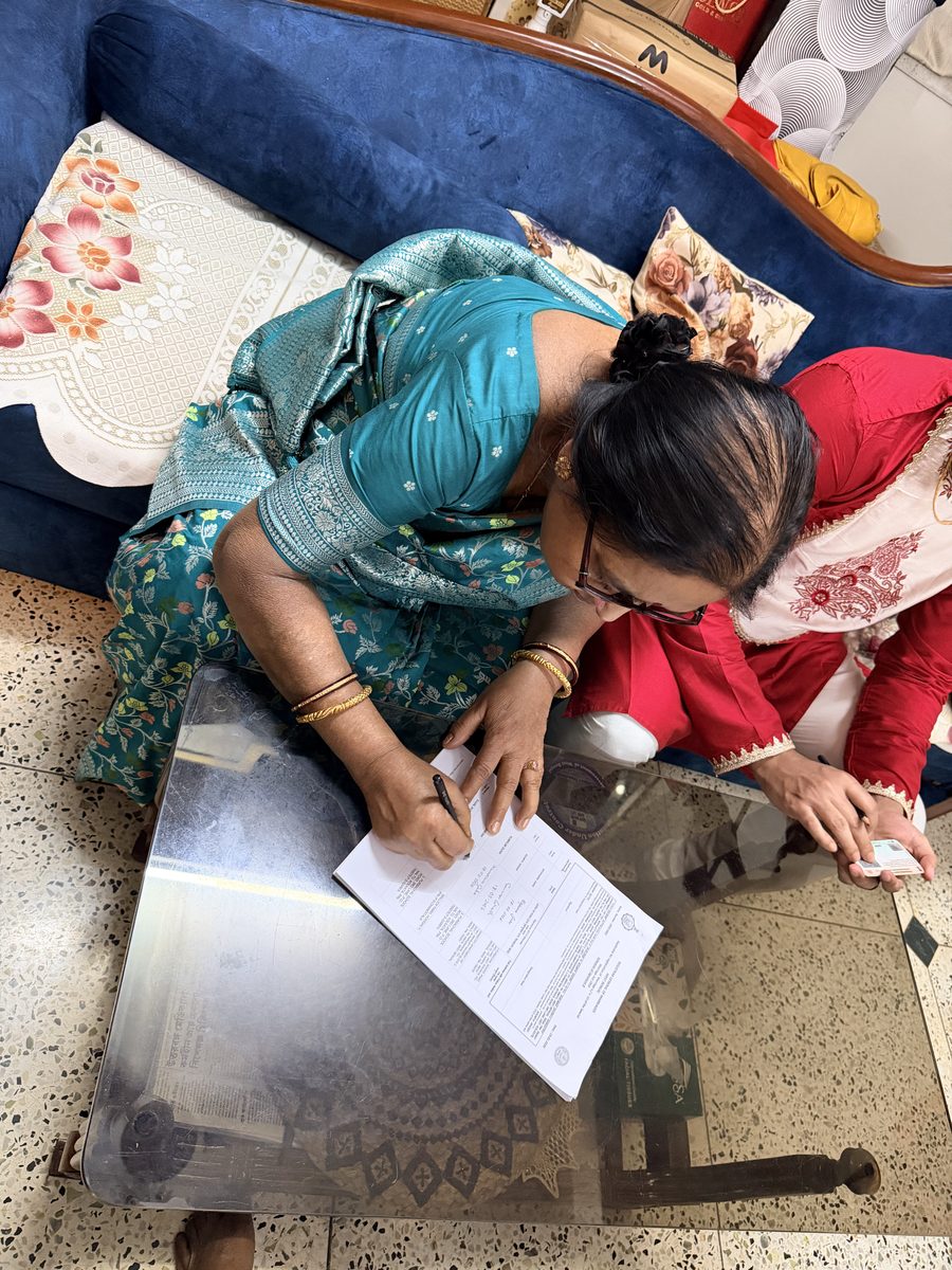 Overhead shot of two people reviewing ceremony documents on the floor