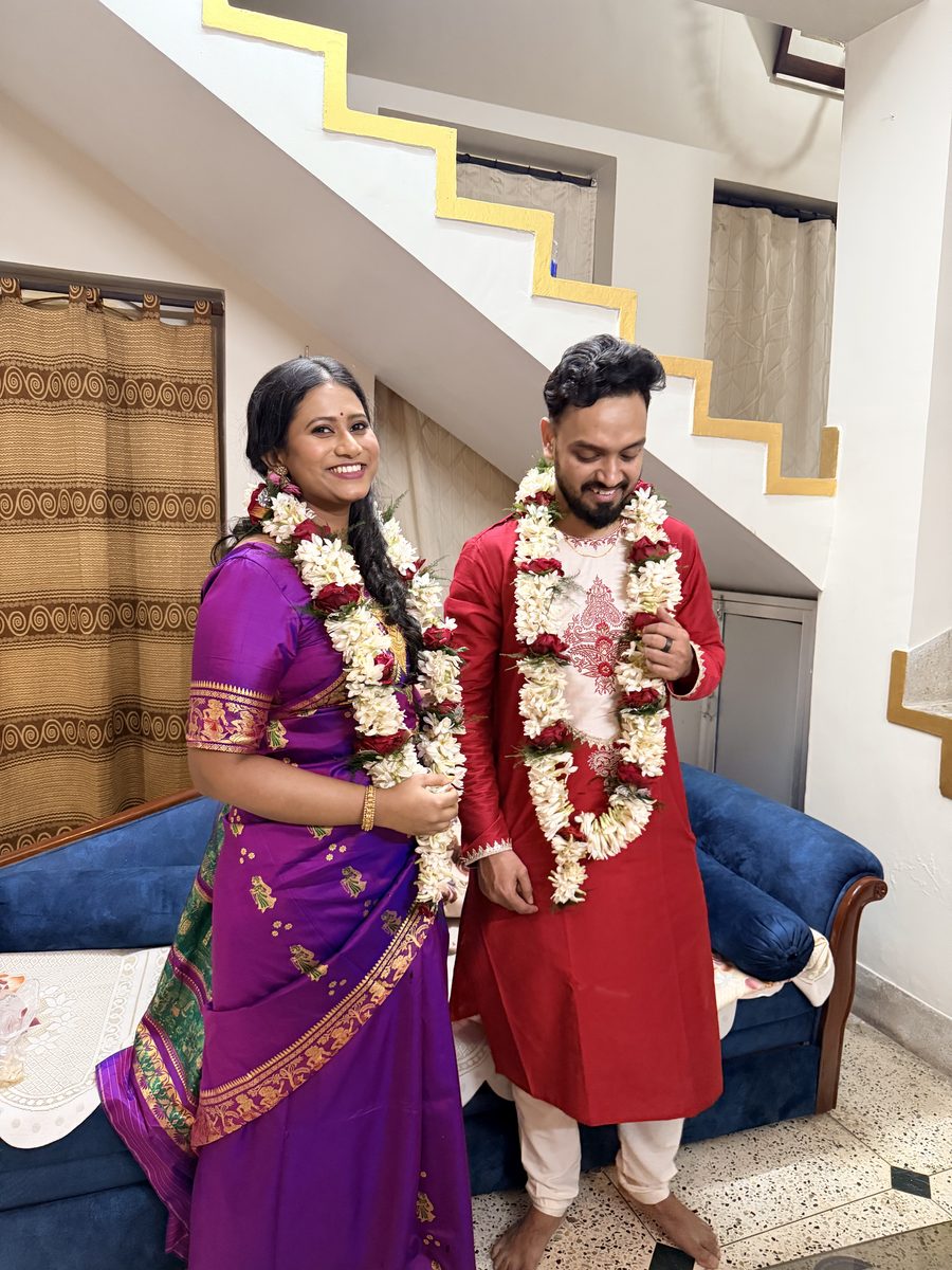 Rituparna in purple Banarasi and Shoumo in red kurta wearing matching garlands
