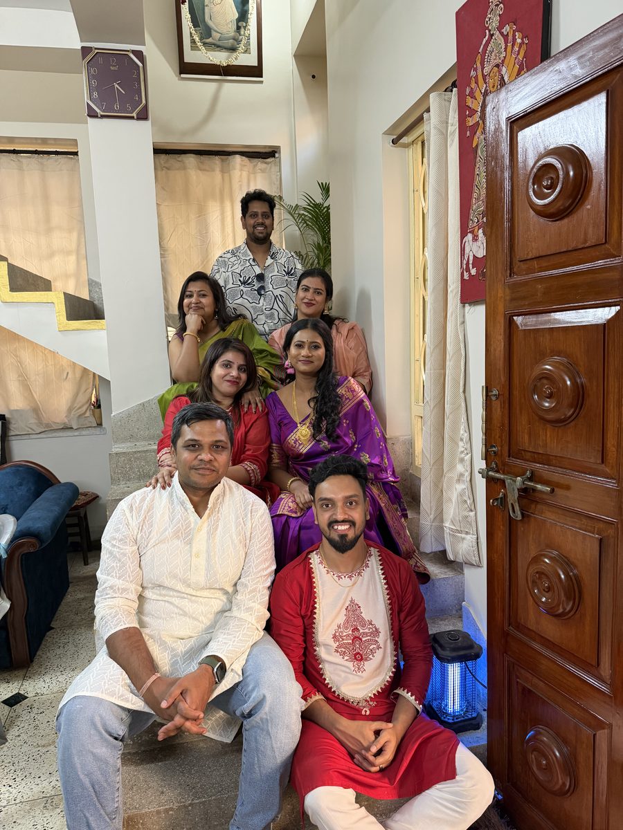 Group portrait at home with Shoumo and multiple relatives in traditional attire