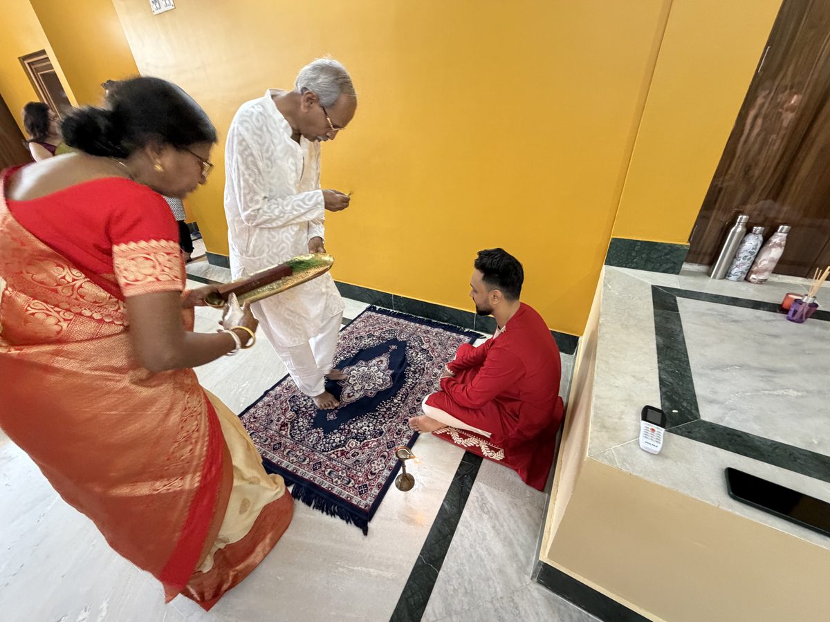 Elder woman and man performing blessing ritual with Shoumo kneeling