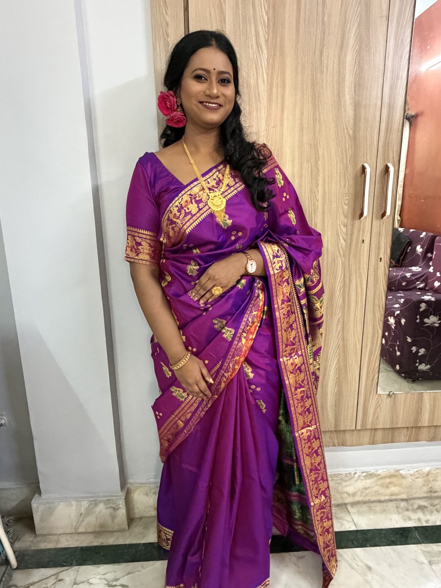 Rituparna in her purple Banarasi with flower decorations in her hair, portrait