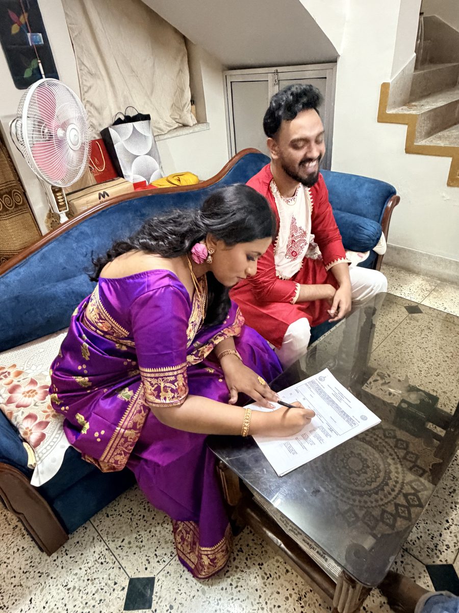 Elder woman in orange blessing Shoumo with a hand gesture
